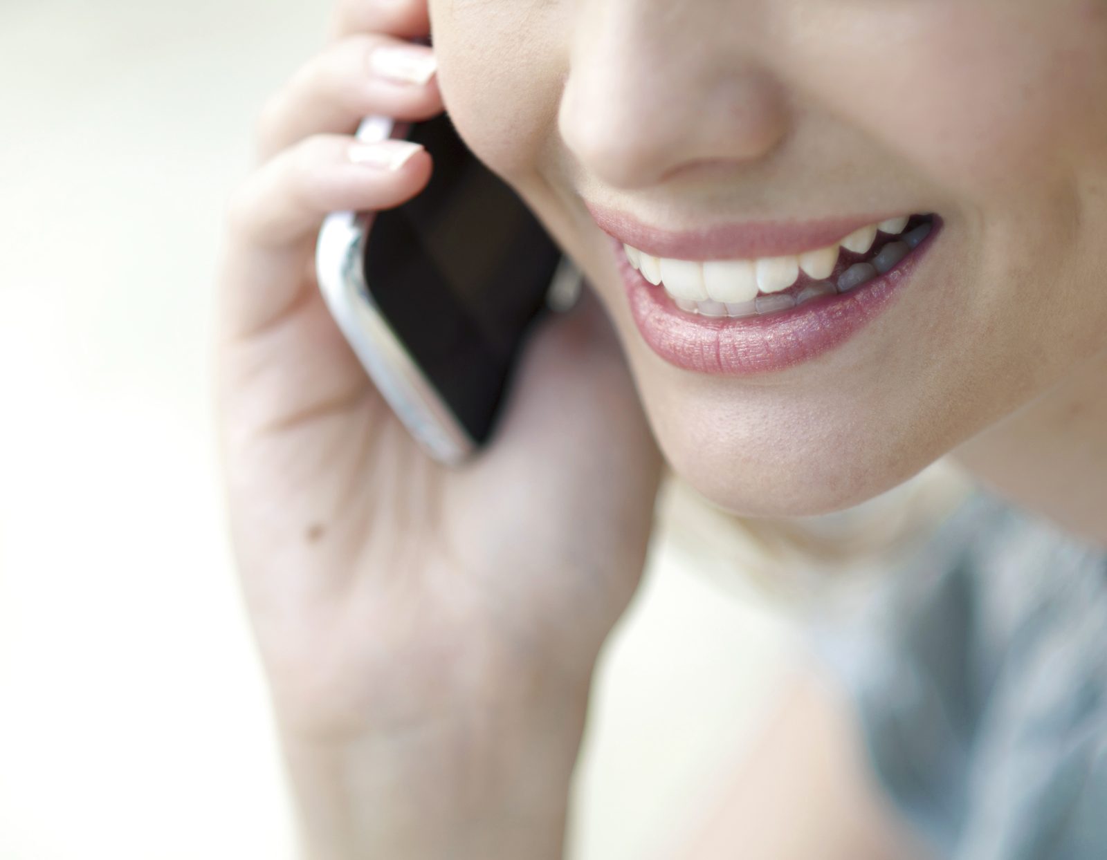 Person smiling while talking on a mobile phone