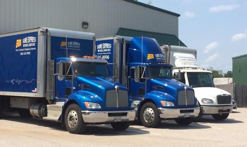 GEM Exhibits box trucks parked outside the warehouse