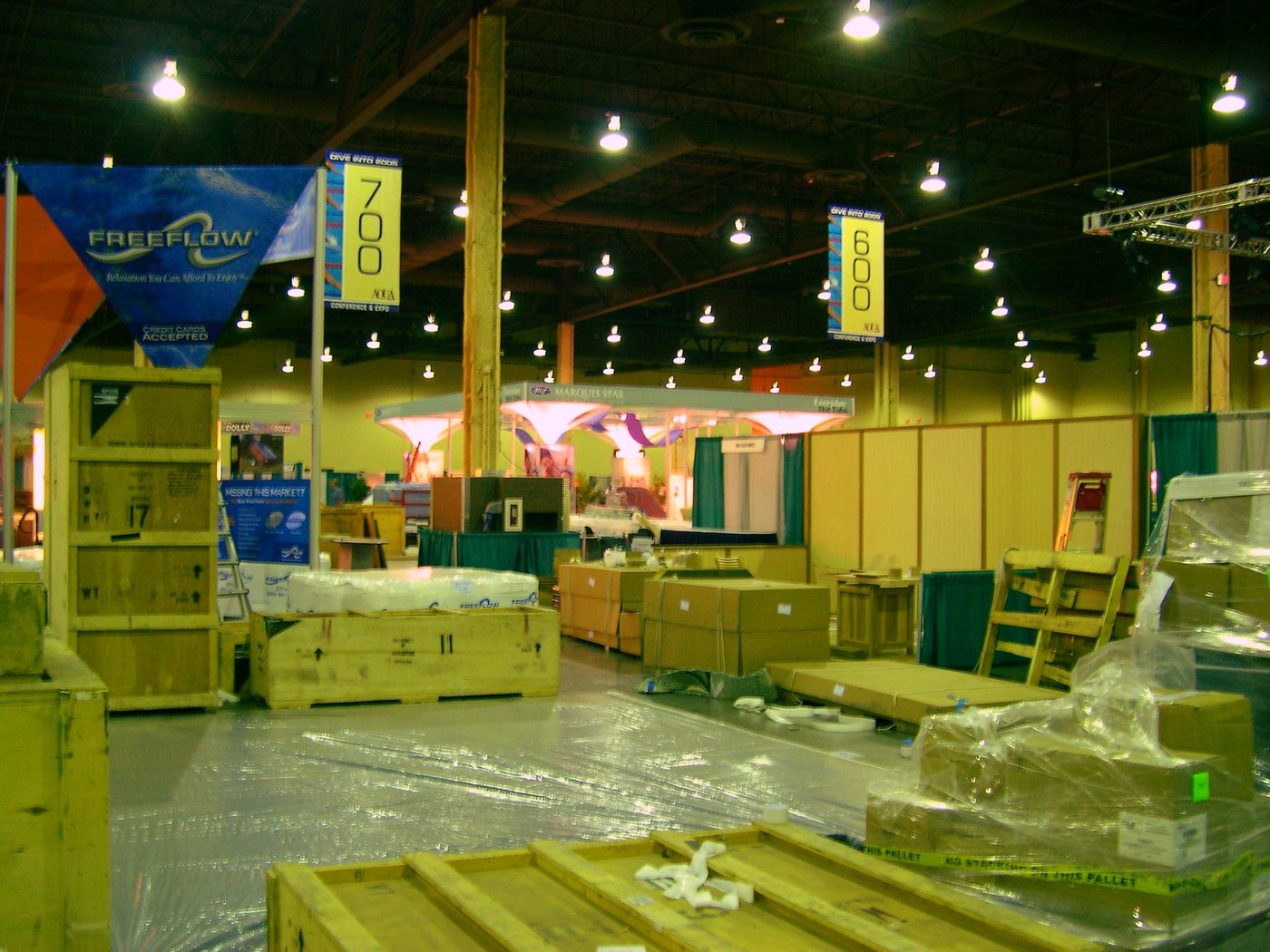 Exhibit properties and machinery staged across a warehouse floor