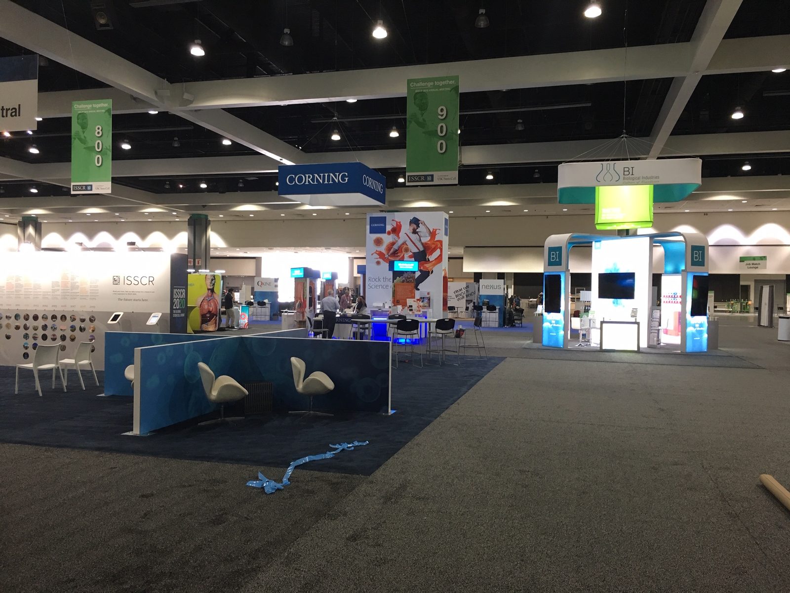 Exhibit hall during set-up with crews assembling stands