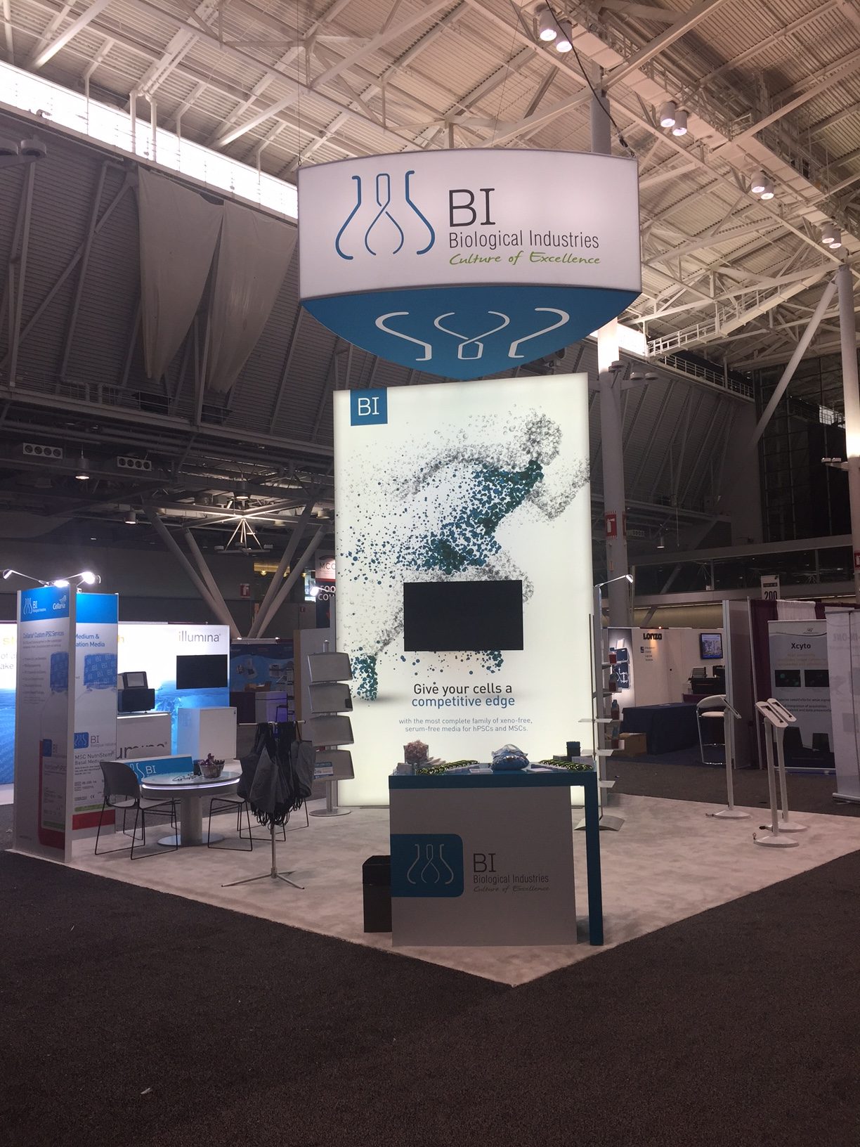 Inline exhibit with a tall printed tower and monitor