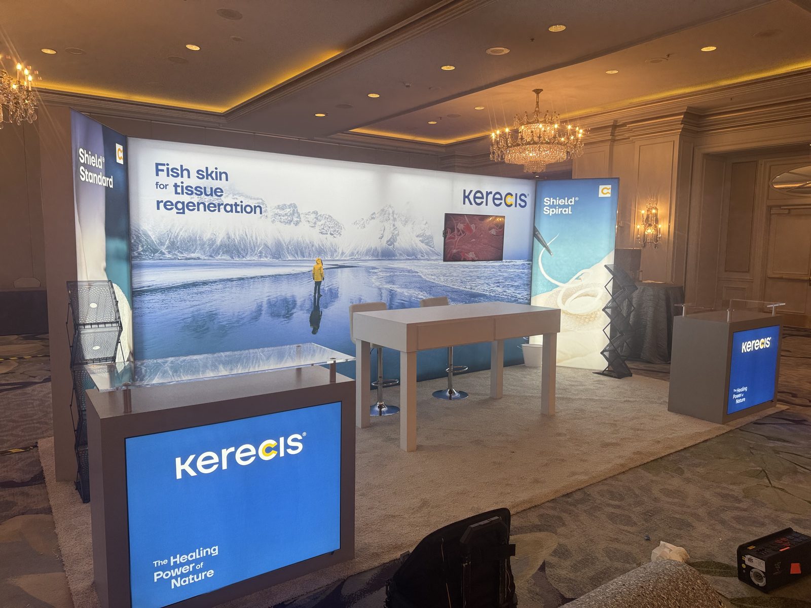 Backlit exhibit with large product imagery and a demonstration counter
