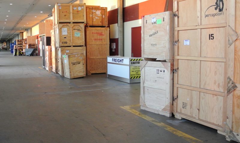 Crated exhibit properties staged in a warehouse aisle